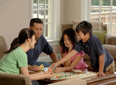 A family sitting around a table playing board games