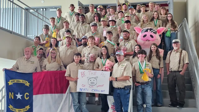North Carolina 4-H Shooting Sports delegation posing together after the National 4-H Shooting Sports Championships, many displaying medals and ribbons.