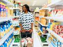 Women pushing grocery cart at store