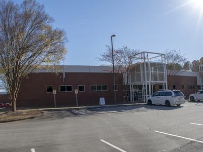Photo from the parking lot showing the front of the building where the PDIC is located