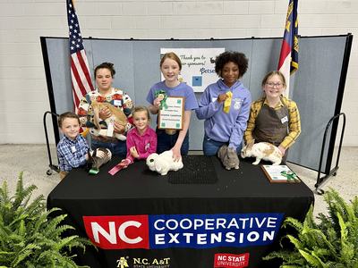 4-h'ers holding ribbons from rabbit show