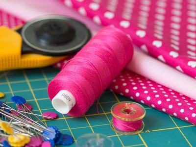 sewing notions such as thread, pins, rotary cutter and bobbin