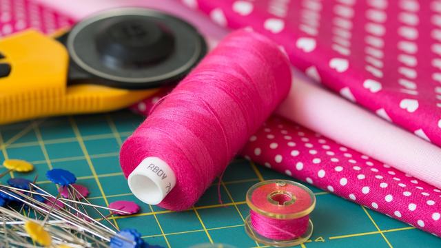 sewing notions such as thread, pins, rotary cutter and bobbin