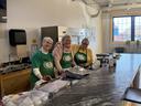Three women volunteering at a community soup luncheon