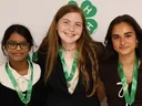 Three 4-H members wearing medals pose for a photo after being recognized during the 2026 North Carolina 4-H State Presentation Finals.