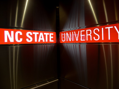 NC State logo signage in a campus elevator