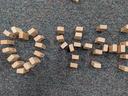 Child's hand giving a thumbs up next to Jenga pieces in the shape of a heart and 4-H.