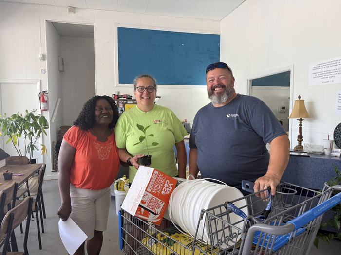 Staff at Yokefellow Helping Center hand out buckets and supplies for the grow bucket program teaching individuals how to garden on a low budget, in limited spaces